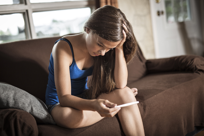 woman looking at pregnancy test