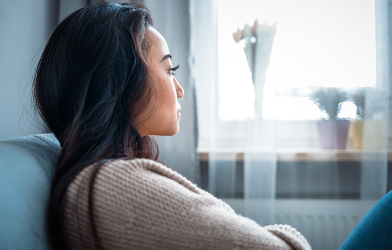 woman looking off to the side with a serious look on her face